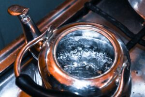 a pot of boiling water sitting on top of a stove