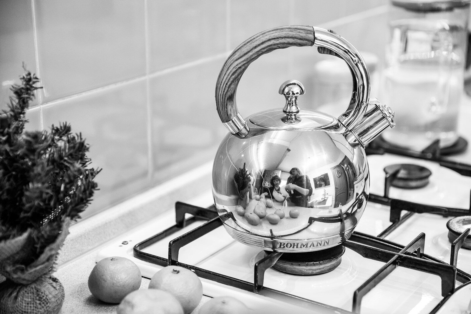 a silver tea kettle sitting on top of a stove